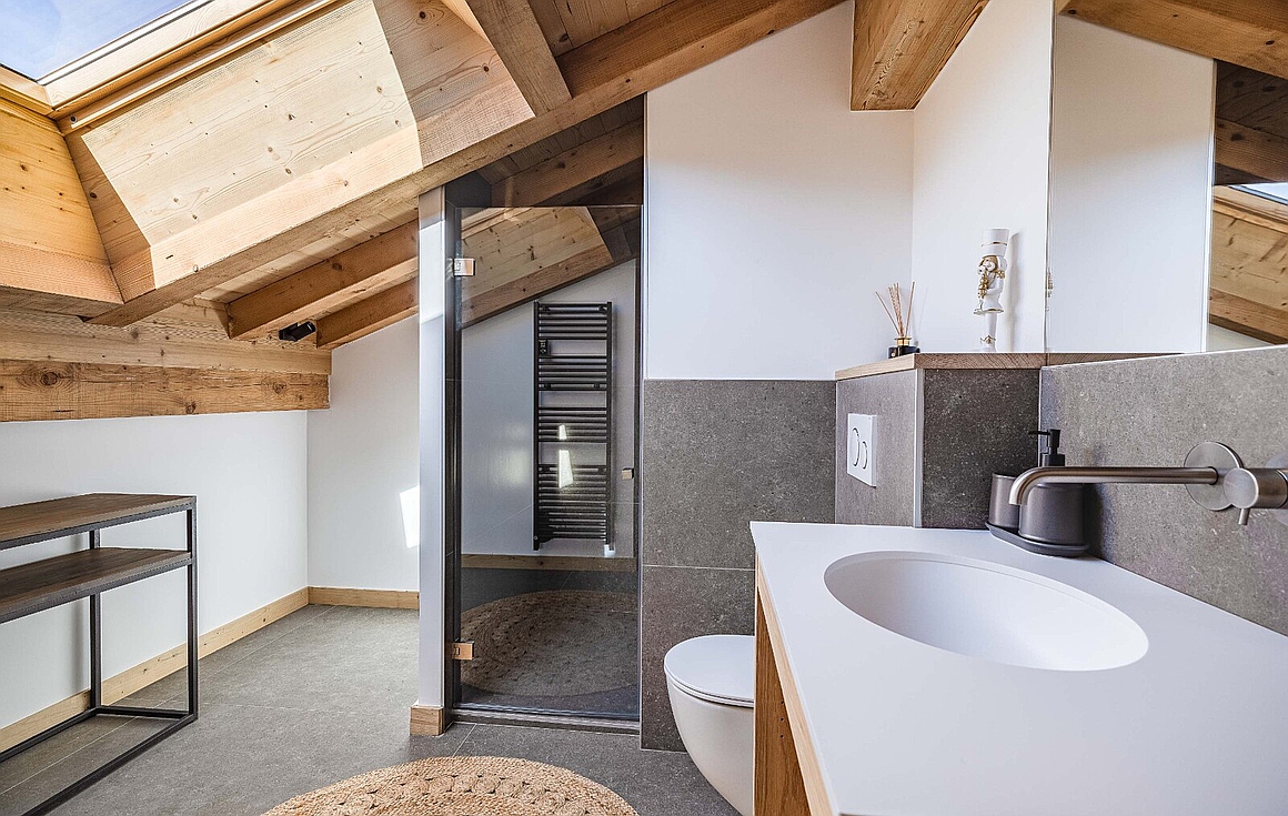 Bright attic bathroom with modern finishes